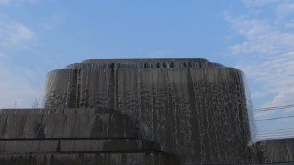 Video 4k of close up of small waterfall with blue sky background