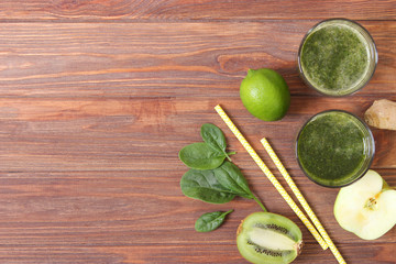 Green smoothie and fresh vegetables on the table for the detox organism top view.