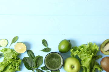 Green smoothie and fresh vegetables on the table for the detox organism top view.