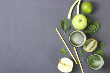 Green smoothie and fresh vegetables on the table for the detox organism top view.