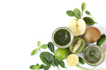 Green smoothie and fresh vegetables on the table for the detox organism top view.