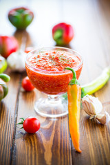 homemade hot adjika from tomatoes, hot and sweet peppers with spices