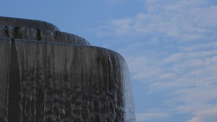 Video 4k of close up of small waterfall with blue sky background