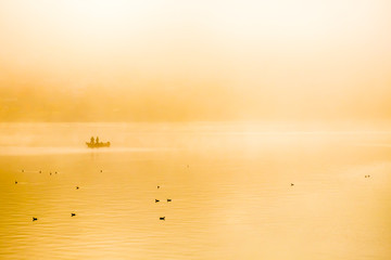 Fishing in the morning fog on the lake in japan