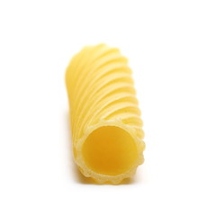 Uncooked short tubes shape pasta also known as tortiglioni or elicoidali isolated on white background