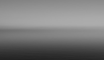 Black and white background of water and sky with the horizon