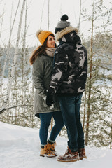Fototapeta na wymiar The happy couple in love at forest nature park in cold season. Travel adventure love story