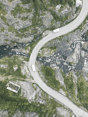 Top view aerial shot of old winding road over stream