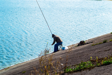 angler with fishing rod on the lake