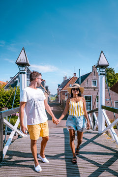 young couple on vacation at the old town of Hindeloopen Friesland Netherlands during summer