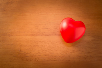 Two red heart shape on wooden background