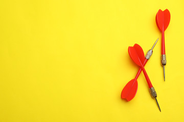 Red dart arrows on yellow background, flat lay with space for text