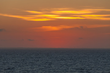 Fototapeta premium Awesome orange sky right after sunset behind the italian coast