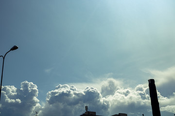 The view of the buildings and open sky has a shade of yellow and green, soaked in toxicity from...