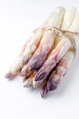 Fototapeta na wymiar Raw white Asparagus with violet head as bunch on white background with copy space - isolated