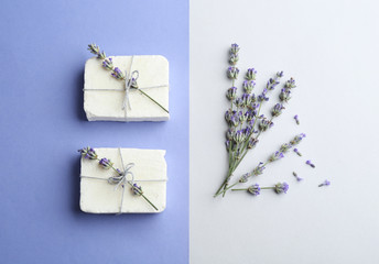 Hand made soap bars with lavender flowers on color background, flat lay