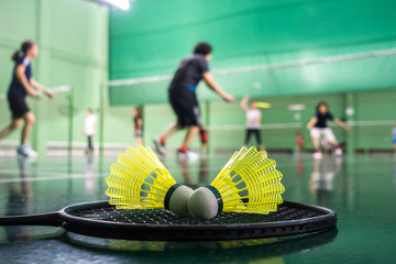 badminton courts with players competing - obrazy, fototapety, plakaty