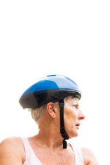 older woman with blue bicycle helmet looking at the sky