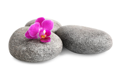 Fototapeta na wymiar Pile of spa stones and orchid flower on white background