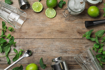Frame made of bar equipment and ingredients for cocktail on wooden table. Space for text