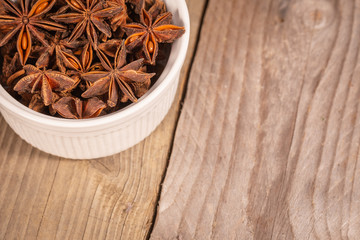 a pile of star anise in a white pot