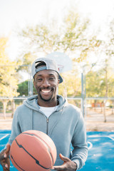 African man practicing on basketball court