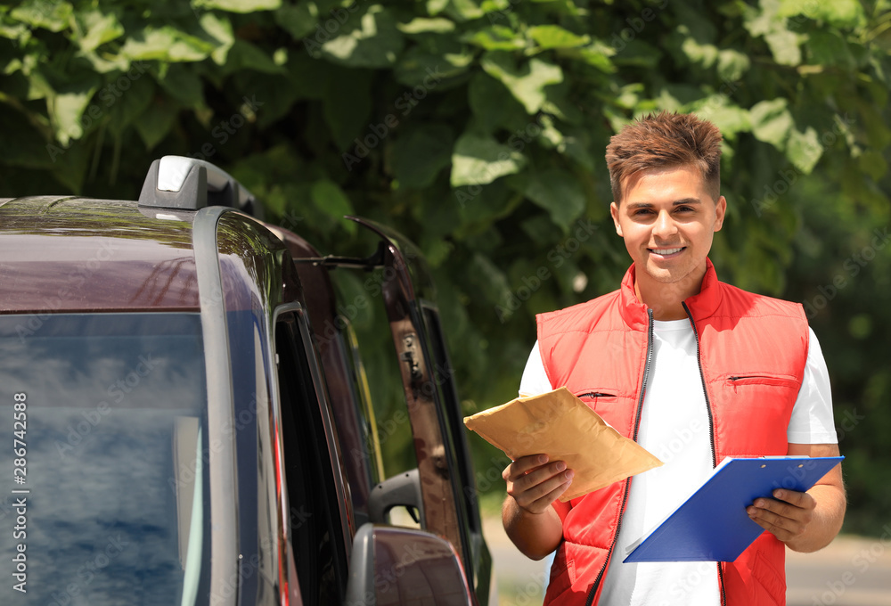 Poster Young courier with clipboard and envelope near delivery car outdoors