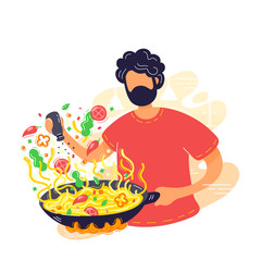 Young man coocking noodles in wok frying pan