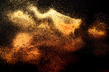 Black background with golden sparkles. Blurred  effect. Concept for festive background or for project