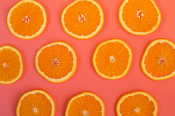 Background of ripe oranges cut on pink background