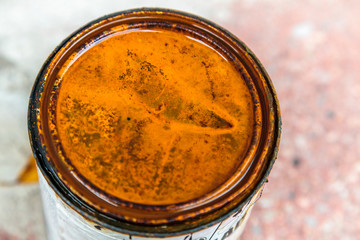 A rusted lid of a can of used paint