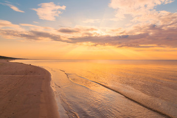 Beautiful sunset sky with clouds over Baltic sea beach coastline. Jurmala. Latvia.