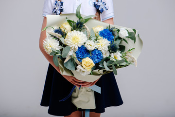 A bouquet of of flowers in the hands of girl