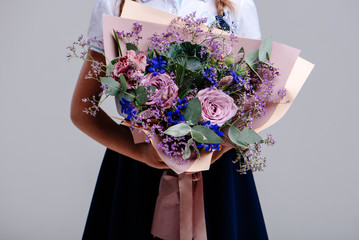 A bouquet of of flowers in the hands of girl