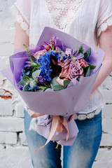 A bouquet of of flowers in the hands of woman
