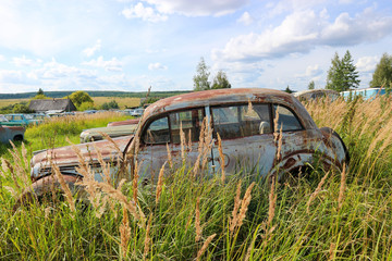 Beautiful vintage abandoned rusty old car in the grass