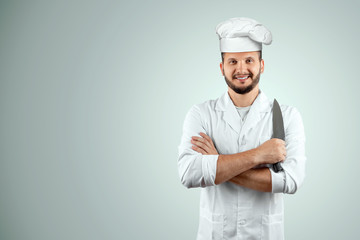 A man with a beard, a cook in a hat and a knife in his hand Isolated on a white background. Cooking, recipes, cuisine.