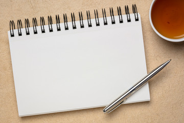 blank spiral art sketchbook with tea