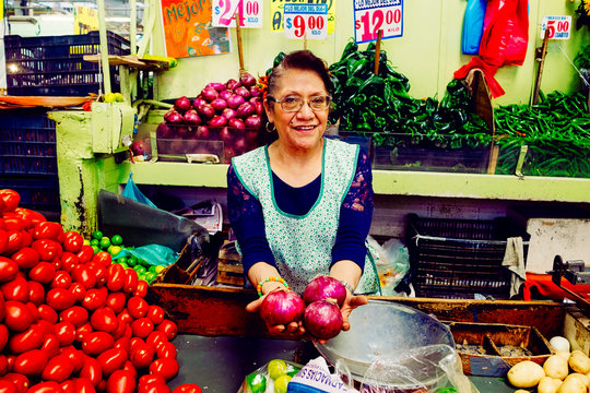 Woman showing onions in market