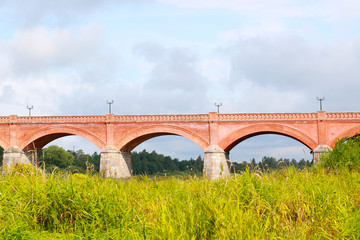 ancient red brick bridge over the river