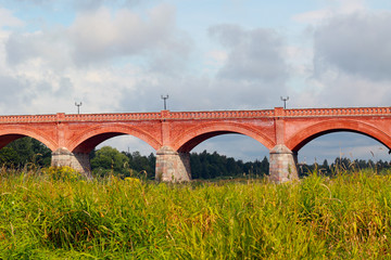 ancient red brick bridge over the river