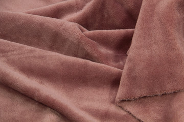 Fototapeta premium The blanket of furry fleece fabric. A background soft plush fleece material with a lot of relief folds