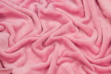 The blanket of furry fleece fabric. A background soft plush fleece material with a lot of relief...