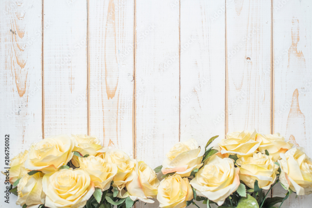 Wall mural top view of wedding flowers on white wood background