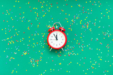 Christmas pattern flat lay with red alarm clock