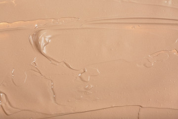 Obraz premium Concealer smear makeup texture background. Liquid foundation.