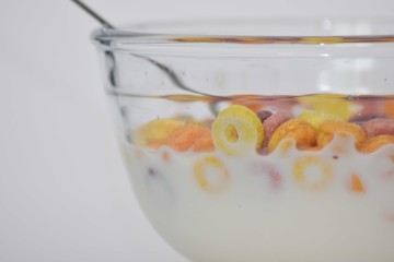 Multi color cereal bowl with milk on white background