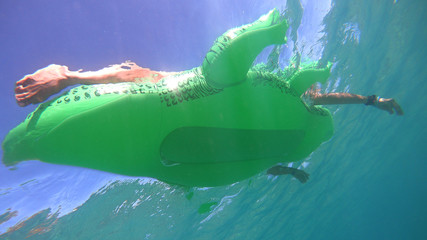 Underwater photo of inflatable crocodile as seen in tropical beach
