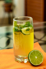 glass of fresh mojito with lime on an orange background, a drink close-up, cocktail, lime ,lemon