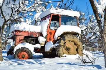 Old tractor parked in the snow